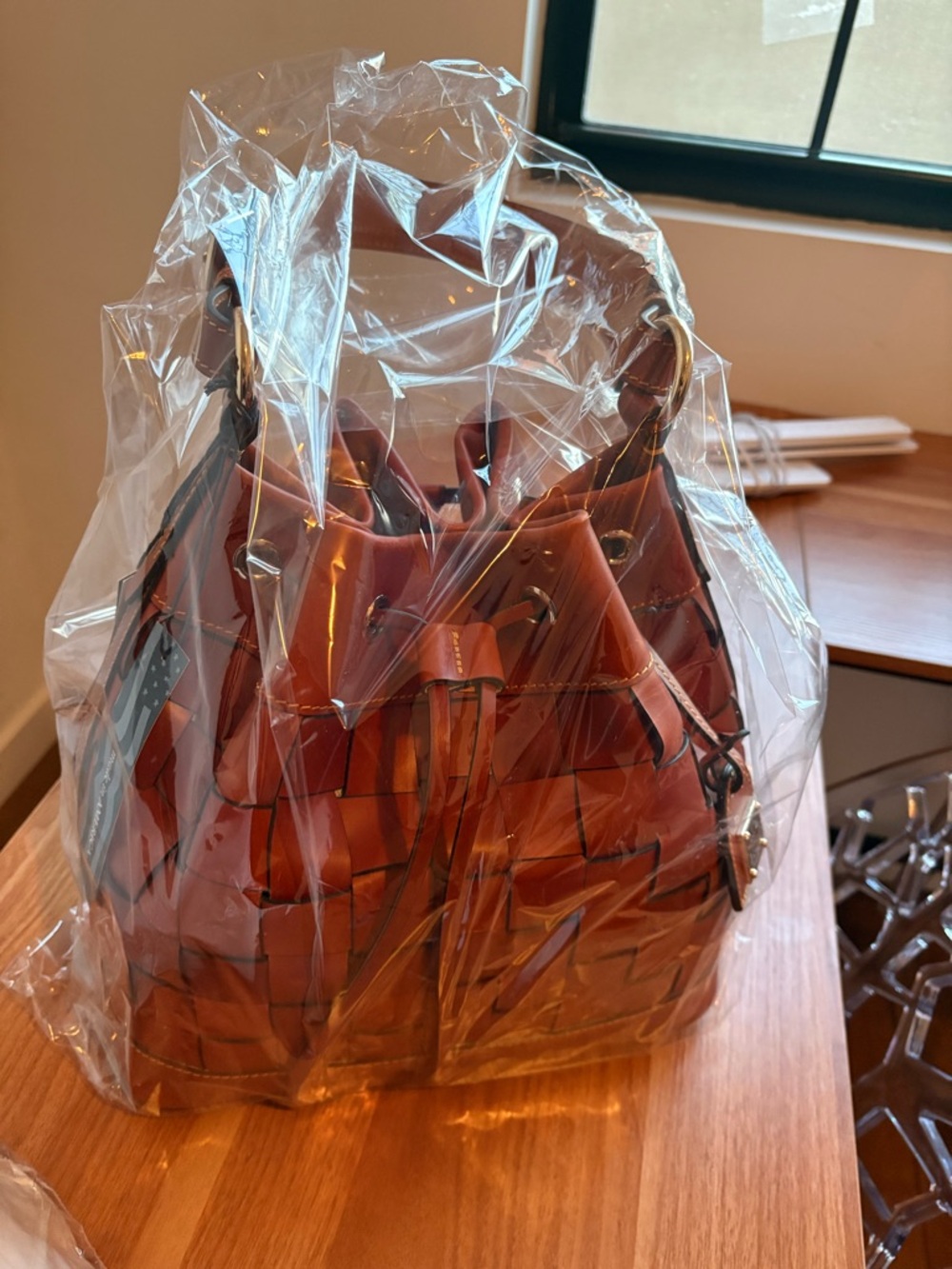 Dooney & Bourke Woven Belmar 30 Drawstring Shoulder Bag in tan.